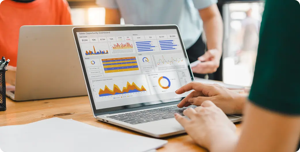 Laptop displaying data charts and graphs